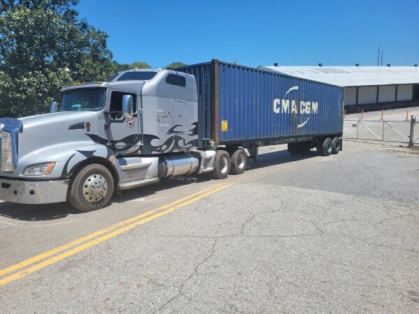 Truck hauling a shipping container